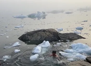 A photo of Dr. Cha doing a polar plunge in Greenland